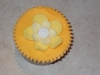 Vanilla cupcake with orange coloured butter cream with Yellow Flowers